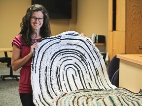 Sarah Pawson displays a couple of 'braided' rugs that she has made. Many of her 100% recycled pieces help to raise funds for the Cochrane Food Bank.