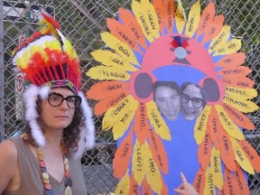 A teacher in Montreal wears a headdress in this handout image posted online on Monday, Aug. 29, 2016. A Quebec mother says she was shocked that two teachers were wearing aboriginal headdresses and handing them out on the first day at a Montreal primary school. (THE CANADIAN PRESS/HO-Jennifer Dorner)