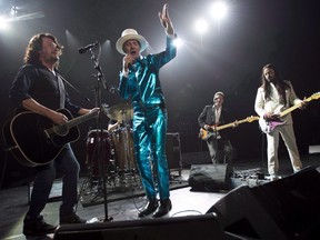 Frontman of the Tragically Hip, Gord Downie, centre, leads the band through a concert in Vancouver on July, 24, 2016. Canada's insatiable appetite for the Tragically Hip sent the rock band's entire discography back onto the Billboard charts last week. THE CANADIAN PRESS/Jonathan Hayward