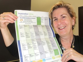 Lynda Breen, supervisor of recreation programs for the city, holds up a list of events for September's Kingston Gets Active month, in Kingston, Ont. on Tuesday, August 30, 2016. The month is designed to encourage people to try out different physical activities. Michael Lea The Whig-Standard Postmedia Network