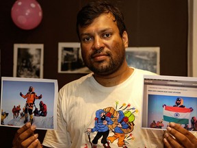 In this July 4, 2016 file photo, Indian climber, Satyarup Sidhantha holds on his right hand a photograph that shows him on Mount Everest, along with what he says is an altered version of the same used by an Indian couple to make it appear they were on the summit, as he displays them for the Associated Press in Kolkata, India. Nepal mountaineering authorities have determined that an Indian couple faked a Mount Everest ascent earlier this year by altering photographs to show they were on the summit. (AP Photo/ Bikas Das, File)
