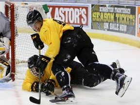 Nathan Dunkley, top, battles for the puck with Justin Pringle during the second day of the Kingston Frontenacs training camp at the Rogers K-Rock Centre. (Ian MacAlpine/The Whig-Standard)
