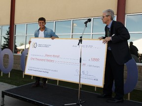 Devon Koroll (left) is recognized by Dan MacLennan, executive director of the Alberta Construction Safety Association, as ACSA's one millionth student to take safety training in Alberta during a ceremony at the ACSA campus in Edmonton, Alberta on Tuesday, August 30, 2016.