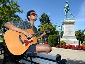 Mahder Mehari plays his guitar in a shady spot in Victoria Park. There have been 19 days this summer when the temperature was 30 C or higher, with more plus-30 C days possible. In an average year, London would get only 10 days that topped 30 C. (MORRIS LAMONT, The London Free Press)