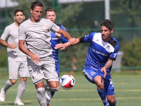 FC Edmonton midfielder Nicolas Di Biase, right, challenges Puerto Rico FC forward Pedro Mendes for the ball in North American Soccer League play at Clarke Stadium on Sunday, Aug. 28, 2016.