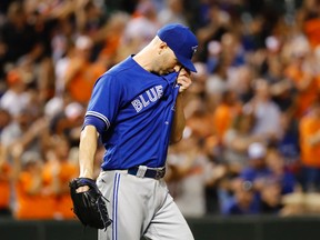 Toronto Blue Jays starting pitcher J.A. Happ wipes his face after giving up a two-run home run to Baltimore Orioles' Manny Machado on Aug. 30, 2016. (AP Photo/Patrick Semansky)