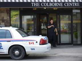 A police officer leaves 323 Colborne Street on Tuesday August 30, 2016 where London police found the body of Nathan Deslippe after receiving a 911 call to an 18th floor apartment on Sunday. MORRIS LAMONT/THE LONDON FREE PRESS /POSTMEDIA NETWORK
