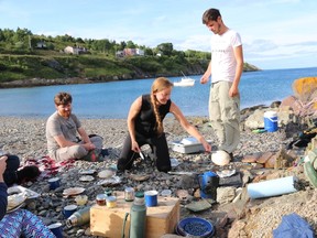 Lori McCarthy of Cod Sounds, a culinary adventure company, serves up a meal of fresh mussels, cod and scallops garnished with wild herbs and blueberries near Avondale, N.L., on Sunday, Aug. 21, 2016. THE CANADIAN PRESS/HO-Mike Wert