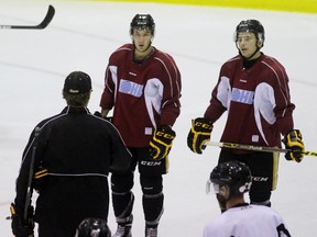 Sarnia Sting head coach Derian Hatcher explains a drill to forwards Anthony Salinitri and Troy Lajeunesse during practice at Progressive Auto Sales Arena on Wednesday, Aug. 31, 2016 in Sarnia, Ont. Sarnia's training camp roster is down to 24 from the original group of 42. Terry Bridge/Sarnia Observer/Postmedia Network