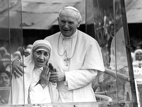 Pope John Paul II, right, holds his arm around Mother Teresa as they ride in the popemobile outside the Home of the Dying in Calcutta, India, in this February 1986 photo. When Pope Francis canonizes Mother Teresa on Sunday, Sept. 4, 2016, he'll be honouring a nun who won admirers around the world and a Nobel Peace Prize for her joy-filled dedication to the “poorest of the poor.” (AP Photo, files)