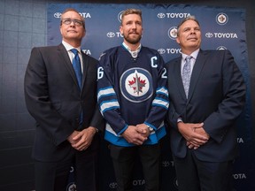 Winnipeg Jets head coach Paul Maurice, left to right, forward Blake Wheeler and general manager Kevin Cheveldayoff pose for a photo after Wheeler was named the new captain of the Jets during a press conference in Winnipeg on Wednesday, August 31, 2016. The team confirmed Thursday, Sept. 7, 2017, the coach and GM have been signed to multi-year contract extensions. THE CANADIAN PRESS/David Lipnowski