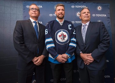 Winnipeg Jets head coach Paul Maurice, left to right, forward Blake Wheeler and general manager Kevin Cheveldayoff pose for a photo after Wheeler was named the new captain of the Jets during a press conference in Winnipeg on Wednesday, August 31, 2016. The team confirmed Thursday, Sept. 7, 2017, the coach and GM have been signed to multi-year contract extensions. THE CANADIAN PRESS/David Lipnowski