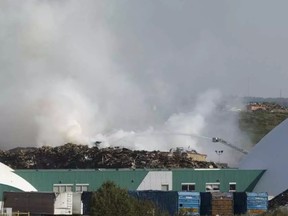 Smoke from a fire at a dump in northeast Edmonton led Alberta Health Services to issue a precautionary air quality advisory Tuesday night. IAN KUCERAK
