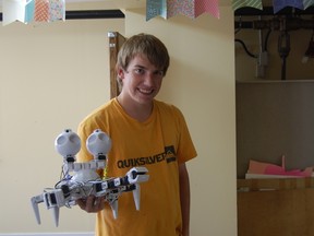 Austin Ford holds up the robot he designed and programmed during his week at RCADE's "Coder Rodeo."