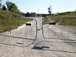 Locked gates bar access to a quarry on Amherst Island, Ont. on Wednesday, Aug. 30, 2016. Access to and ownership of the aggregate in the quarry is the subject of an ongoing legal dispute. Elliot Ferguson/The Whig-Standard/Postmedia Network