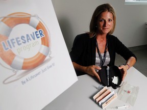 Luke Hendry/The Intelligencer
Public health nurse Christie Reeve holds a training kit similar to those used to prevent overdoses of opioid drugs in Belleville Wednesday. The kits can reverse the effects of an overdose - but only temporarily. They'll be available from Hastings Prince Edward Public Health starting this fall.