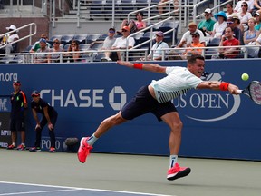 Milos Raonic returns a shot to Ryan Harrison during the second round of the U.S. Open in New York on Wednesday, Aug. 31, 2016. (Alex Brandon/AP Photo)