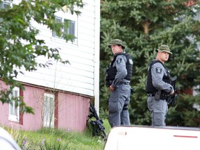 Members of the Greater Sudbury Police Tactical Unit wait for a man to surrender at the scene of the weapons complaint  in Levack, Ont. on Wednesday August 31, 2016. The standoff ended peacefully around 8:30 after five and a half hours with a male suspect in custody. Gino Donato/Sudbury Star/Postmedia Network