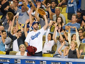 Actor Tony Hale does the wave at a baseball game between the Arizona Diamondback and the Los Angeles Dodgers at Dodger Stadium on Sept. 22, 2015. (Noel Vasquez/GC Images)
