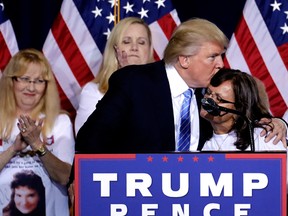 Republican presidential candidate Donald Trump embraces the mother who child was killed by a person living in the country without legal permission after delivering an immigration policy speech during a campaign rally at the Phoenix Convention Center, Wednesday, Aug. 31, 2016, in Phoenix. (AP Photo/Matt York)