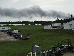 Smoke rises from a SpaceX launch site Thursday, Sept. 1, 2016, at Cape Canaveral, Fla. NASA said SpaceX was conducting a test firing of its unmanned rocket when a blast occurred. (AP Photo/Marcia Dunn)