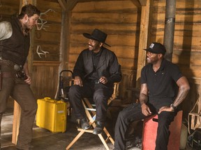 In this image released by MGM/Columbia Pictures, actors Chris Pratt, left, and Denzel Washington, center, appear on the set with director Antoine Fuqua during the filming of "The Magnificent Seven." (Sam Emerson/MGM/Columbia Pictures via AP)