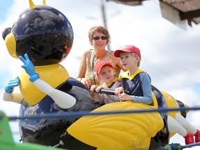 Emily Mountney-Lessard/The Intelligencer
Leaf Worsley with two of her sons, Ares, four, and Odin, seven, enjoy a ride at the Quinte Exhibition during the Terrific Thursday event at the fairgrounds, on Thursday. The Bancroft family was invited by the Canadian Cancer Society to take part in the event as nine-year-old Mars, who was on the ride with Shawn Waites of Belleville Fire Department, just completed treatment for Leukemia.