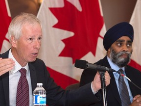 Foreign Affairs Minister Stephane Dion, left, responds to reporters questions as Defence Minister Harjit Sajjan looks on at a news conference at CFB Bagotville in Saguenay Quebec on Friday, August 26, 2016 The Liberal government is putting the United Nations on notice that Canada is ready to provide money and, more importantly, troops for peacekeeping missions around the world. THE CANADIAN PRESS/Jacques Boissinot
