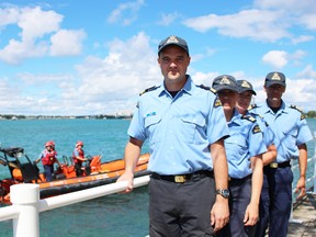 Canadian Coast Guard officers Michael Brown, Mandy Bartley and Kathleen Getty are pictured here with Peter Garapick, superintendent of search and rescue, alongside a coast guard boat travelling the St. Clair River Thursday. Garapick attended meetings with Canadian and U.S. agencies this week to review the massive rescue operation his agency was involved in as a result of this year's Port Huron Float Down. (Barbara Simpson/Sarnia Observer)