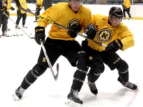 Forward Lawson Crouse, left, battles for the puck with Austin Grzenia during the Kingston Frontenacs training camp at the Rogers K-Rock Centre. (Ian MacAlpine/The Whig-Standard)