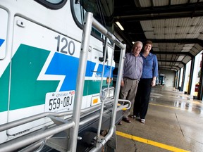 London Transit Commission director of transportation and planning John Ford and general manager Kelly Paleczny stand in a row of buses at the Highbury Avenue depot in London. The LTC is undergoing an overhaul that will see route names change, some routes modified while others will be cancelled, and the addition of new routes and 17,000 annual hours of service, effective September 4. (CRAIG GLOVER, The London Free Press)