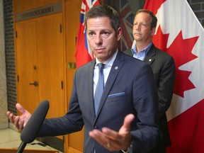 Winnipeg Mayor Brian Bowman (left) and city councillor John Orlikow speak about the new home development fee report during a press conference in Winnipeg, Man. Thursday Sept. 1, 2016.