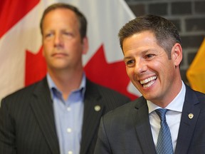 Winnipeg Mayor Brian Bowman (right) and city councillor John Orlikow speak about the new home development fee report during a press conference in Winnipeg, Man. Thursday Sept. 1, 2016.