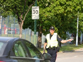 Winnipeg Police Constable Ray Howes pulls over a driver for speeding in a school zone Thursday.
