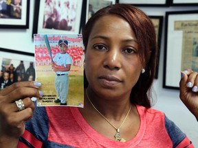 Maribel Martinez holds a photo of her son Andy at her attorney's office, in the Brooklyn borough of New York, Thursday, Sept. 1, 2016. Martinez says she hasn't stopped crying since JetBlue airlines mistook her 5-year-old for another child and flew him to the wrong city. (AP Photo/Richard Drew)