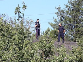 Greater Sudbury Police Service officers guard the scene across from College Boreal in Sudbury, Ont. on Thursday September 1, 2016. A woman's body was found at the site on Wednesday evening, No foul play is suspected.  Gino Donato/Sudbury Star/Postmedia Network