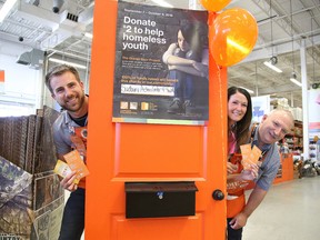 Cale Meeks, store manager, Debbie Rancourt, head cashier and Ivan Duchesne department supervisor at The Home Depot, helped kick off the company's annual Orange Door Project campaign in Sudbury, Ont. on Thursday September 1, 2016. Gino Donato/Sudbury Star/Postmedia Network