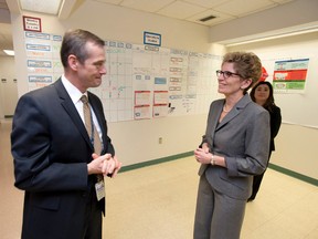 Premier Kathleen Wynne talks with Toronto East General Hospital president and CEO Rob Devitt in this file photograph from 2012, while Wynne was seeking the Liberal party's leadership. Devitt has been appointed supervisor of the Chatham Kent Health Alliance and began work Thursday in Chatham. Frank Gunn/The Canadian Press