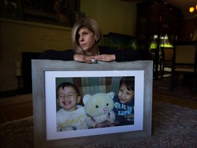 Tim Kurdi sits for a photograph with a photo of her late nephews Alan, left, and Ghalib Kurdi at her home in Coquitlam, B.C., on Monday August 22, 2016. The young Syrian boys and their mother died last year after the small rubber boat they were in capsized during a desperate voyage from Turkey to Greece. THE CANADIAN PRESS/Darryl Dyck