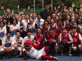 Prime Minister Justin Trudeau and former NBA player Yao Ming pose with students after a basketball game at the Nanyang Model Private High school in Shanghai, Friday September 2, 2016. THE CANADIAN PRESS/Adrian Wyld