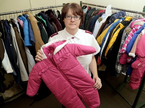 Salvation Army Capt. Stephanie Watkinson, in a file photo from 2014, with the numerous coats donated for the annual Operation Coverup campaign. File photo/Chatham Daily News