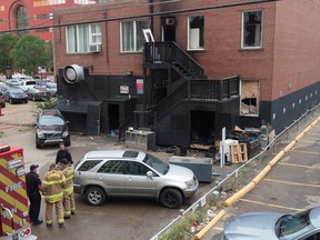 Fire investigators were looking over the scene of an early morning fire in the rear of a building near 100 Avenue and 105 street on September 2, 2016.  Photo by Shaughn Butts / Postmedia