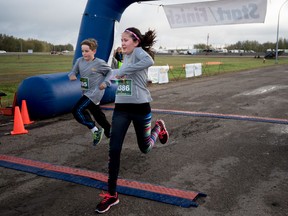 Youngsters run across the finish line at last year’s Rotary Run for Life. This year’s event features youth pricing to encourage more participation from the younger generation. - File photo