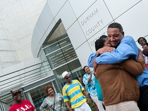 Darryl Howard hugs his wife, Nannie, after being released from the Durham County Detention Facility on Wednesday, Aug. 31, 2016, in Durham, N.C. During an evidentiary hearing, Judge Orlando Hudson threw out a double-murder conviction against Howard and ordered that he get a new trial in the murders of Doris and Nishonda Washington. (Kaitlin McKeown/The Herald-Sun via AP)
