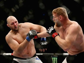 Ben Rothwell (left) tries to avoid a punch from Josh Barnett (right) in the first round of their heavyweight bout during the UFC Fight Night event at the Prudential Center in Newark, N.J., on Jan. 30, 2016. Barnett takes on Andrei Arlovski on Saturday for UFC Fight Night in Hamburg, Germany. (Elsa/Getty Images)