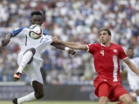 Honduras' Alberth Elis, left, and Canada's Dejan Jakovic, right, fight for the ball during a 2018 World Cup Russia qualifier soccer match in San Pedro Sula, Honduras, Friday, Sept. 2, 2016. Honduras won 2-1. (AP Photo/Arnulfo Franco)