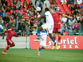 Fury FC’s Lance Rozeboom (right) fights FC Edmonton’s Tomi Ameobi for the ball during NASL action at TD Place. (Ashley Fraser, Postmedia Network)