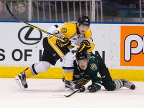 Sarnia Sting forward Travis Konecny and London Knights defenceman Olli Juolevi get tangled up in this Postmedia file photo. The Sting and Knights face off in a second exhibition game Saturday night in Sarnia. Postmedia File Photo
