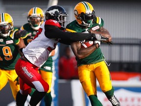 Edmonton Eskimos' Cedric McKinley, right, breaks a tackle by Calgary Stampeders' Maleki Harris during first half CFL pre-season football action in Calgary, Saturday, June 11, 2016. The Eskimos and Stamps face each other for the first time in the regular season on Monday in the Labour Day Classic.