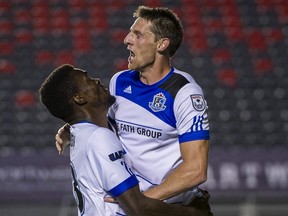 FC Edmonton midfielder Daryl Fordyce, right, celebrates his goal with striker Tomi Ameobi against the Ottawa Fury in North American Soccer League play in Ottawa on Friday, Sept. 2, 2016. The game ended in a 2-2 tie.